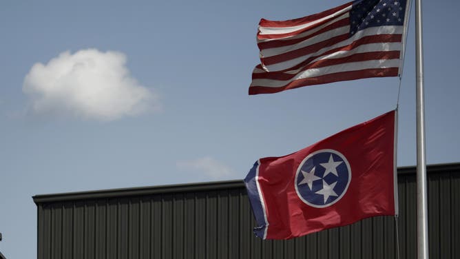 Tennessee flag and U.S. flag fly over Elizabethton, Tennessee.