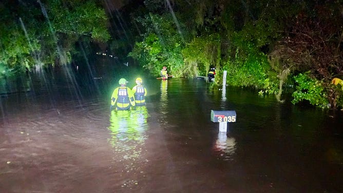 The Orange County Sheriff's Office waded through chest-deep water to checking on homes in a flooded Orlando neighborhood on Thursday morning, Oct. 10, 2024.