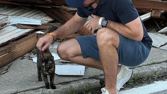 A friendly cat was rescued from a pile of rubble in a neighborhood in Tampa on Friday, October 11, during recovery efforts in the aftermath of Hurricane Milton.