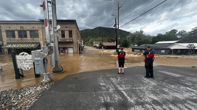 Members of the volunteer Walnut Fire Department swift water rescue team and flooding along the French Broad River after Hurricane Helene.