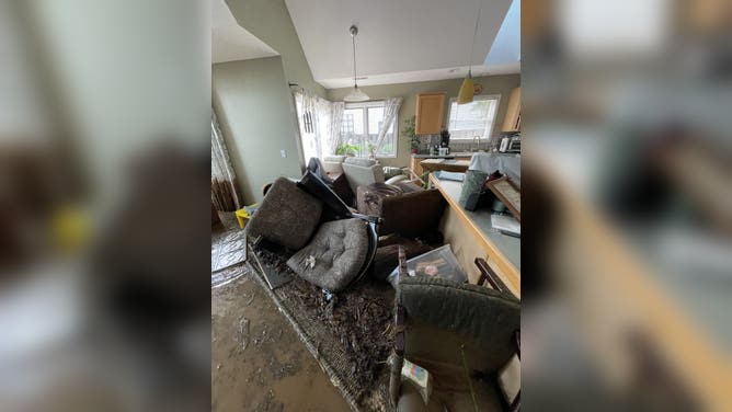 The Riley family's items piled up after the flooding.