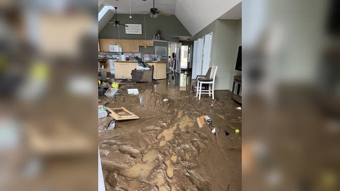 Mud remains after the floodwaters receded in the Riley home.
