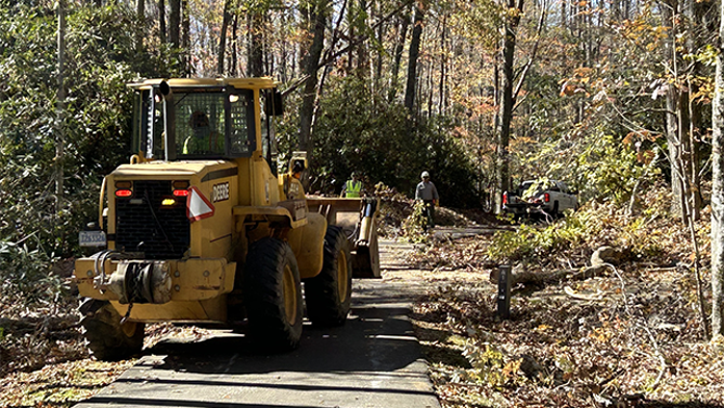 National Park Service crews remove downed trees and debris in the Julian Price Lake area as part of the Hurricane Helene recovery efforts.