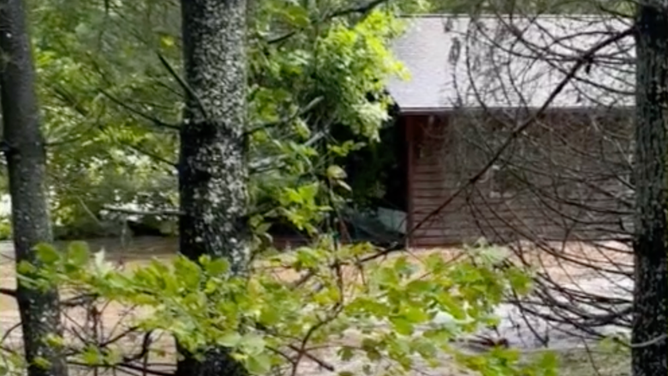 Through the trees, the home could be seen floating down the river.