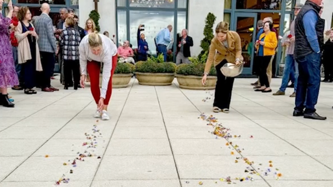 Placing petals to create an "aisle" for the bride.