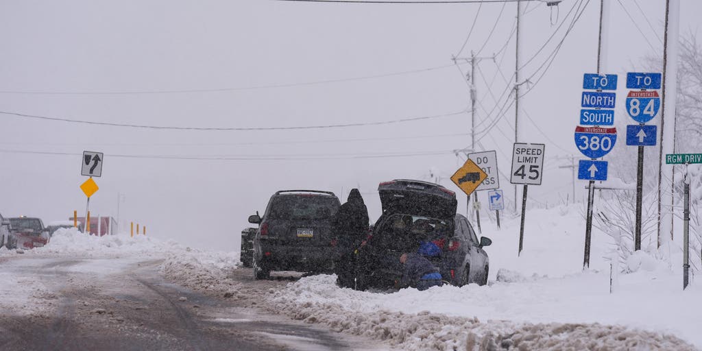 Northeast blasted by snow, beneficial rain as major airport hubs face travel delays