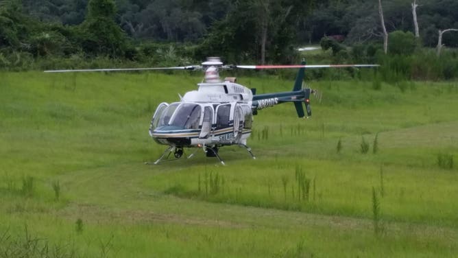 A helicopter lands in the once-empty retention pond near David Musser's home in 2014.