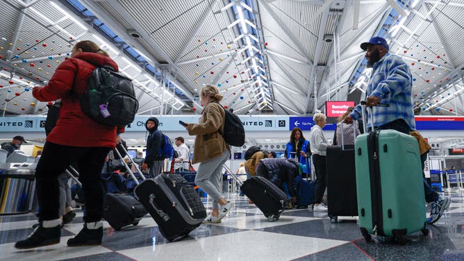 Travelers walk through O'Hare International Airport