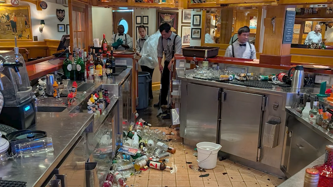 Broken glasses and bottles in the bar on Explorer of the Seas.