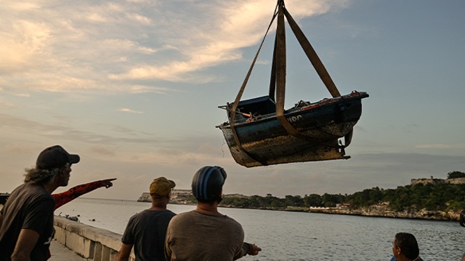 Fishermen take their boats out of the water before Tropical Storm Rafael hits Havana on November 5, 2024. Cuba was preparing for Tropical Storm Rafael, which is expected to hit the island as a hurricane on November 6, compounding the misery caused by a massive power outage and Hurricane Oscar. (Photo by ADALBERTO ROQUE/AFP) (Photo by ADALBERTO ROQUE/AFP via Getty Images)