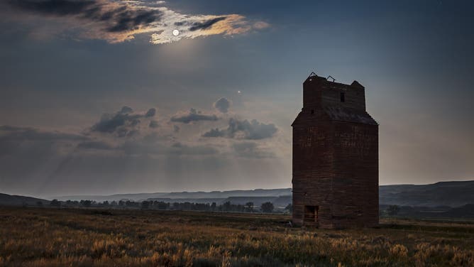 FILE The Full Moon and Mars rising into the southeast over the long abandoned grain elevator at Dorothy, Alberta, in the Red Deer River valley, Alberta This was July 27, 2018. (Photo by: Alan Dyer/VW Pics/UIG via Getty Images)