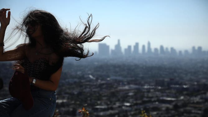 A woman's hair is blown as Santa Ana winds return to Los Angeles. Oct. 18, 2024.