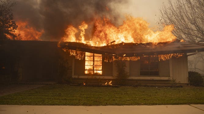 A house is engulfed in flames as the Santa Ana wind-fed Mountain fire scorches acres, in Camarillo, California, on November 6, 2024.
