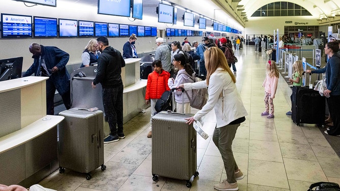 Travelers check in at John Wayne Airport in Santa Ana, CA on Thursday, November 21, 2024.