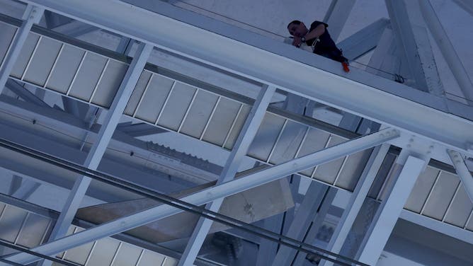 ARLINGTON, TEXAS - NOVEMBER 18: A member of the stadium fixes a part of the roof prior to the game between the Houston Texans and the Dallas Cowboys at AT&T Stadium on November 18, 2024 in Arlington, Texas.
