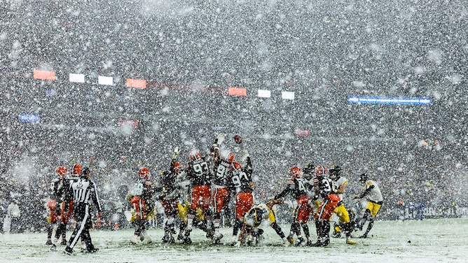 Chris Boswell #9 of the Pittsburgh Steelers kicks a field goal through the snow in the third quarter of the game against the Cleveland Browns at Huntington Bank Field on November 21, 2024 in Cleveland, Ohio.