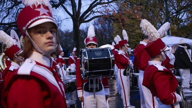 NEW YORK, NEW YORK - NOVEMBER 28: Revelers gather as rain falls before the Annual Thanksgiving Day Parade on November 28, 2024 in New York City.