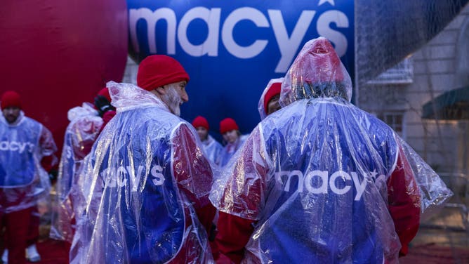 NEW YORK, NEW YORK - NOVEMBER 28: Revelers gather as rain falls before the Annual Thanksgiving Day Parade on November 28, 2024 in New York City.
