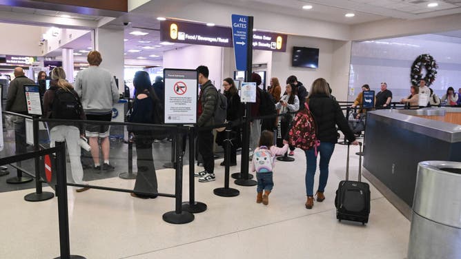 Travelers wait in line to go through Transportation Security Administration (TSA) security checkpoint at the Albany International Airport on Monday, Nov. 25, 2024 in Colonie, N.Y.