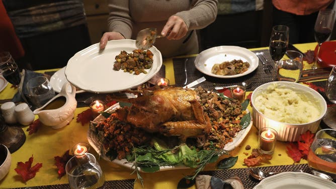 STAMFORD, CT - NOVEMBER 24: A Guatemalan immigrant serves stuffing from the Thanksgiving turkey on November 24, 2016 in Stamford, Connecticut