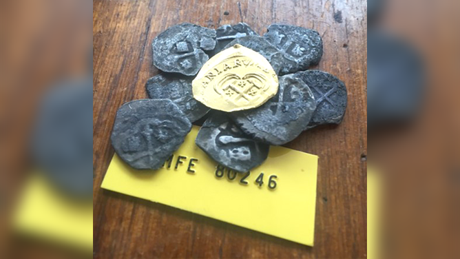 A close-up photo of a gold coin discovered from the 1715 Fleet Shipwreck.