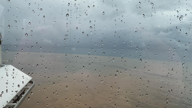 This image shows mud and debris off the Honduras coast at Roatan due to torrential rain from Tropical Depression Nineteen.