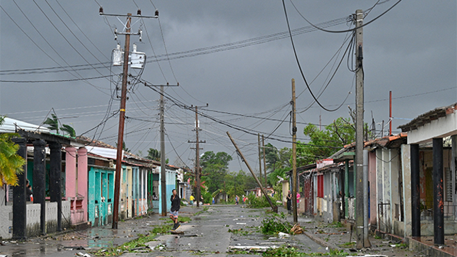 A man walks on a street during the pass of the Hurricane Rafael's eye in Pueblo Candelaria, Artemisa Province, 65 km west of Havana, on November 6, 2024. Hurricane Rafael knocked out power to all of Cuba on Wednesday as it made landfall on the island still reeling from a recent blackout and a previous major storm, the national power company said. (Photo by ADALBERTO ROQUE / AFP) (Photo by ADALBERTO ROQUE/AFP via Getty Images)