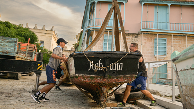 Fishermen protect their boats ahead of the arrival of Tropical Storm Rafael in Havana on November 5, 2024. Cuba was preparing for Tropical Storm Rafael, which is expected to make landfall on the island as a hurricane on November 6, adding to the misery caused by a massive blackout and Hurricane Oscar. (Photo by ADALBERTO ROQUE/AFP) (Photo by ADALBERTO ROQUE/AFP via Getty Images)