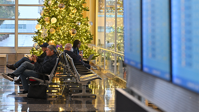 Passengers wait for their flights at Ronald Reagan Washington National Airport in Arlington, Virginia, on November 22, 2024, ahead of the upcoming Thanksgiving holiday. (Photo by ROBERTO SCHMIDT / AFP) (Photo by ROBERTO SCHMIDT/AFP via Getty Images)