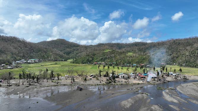 Mud and debris are left behind after Aerial Typhoon Man-yi's damage in Panganiban in the Catanduanes province on Monday morning.