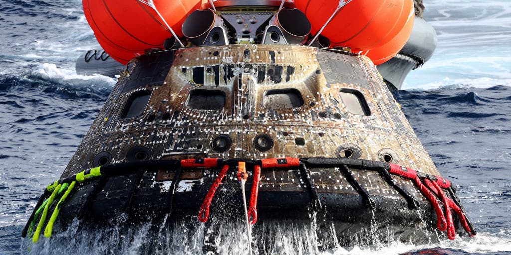 Why will the Artemis II spacecraft land in the ocean and not on land?