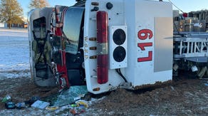 North Carolina firetruck overturns on icy roads as first snow of season creates wintry scenes