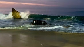 Waves pull Jeep into rough surf as California rescuers work to save driver