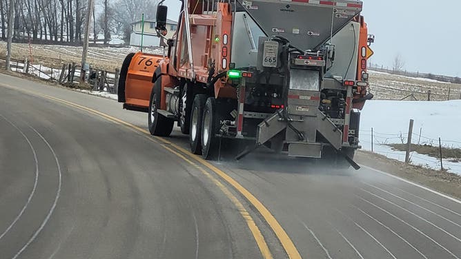 Wisconsin Department of Transportation trucks dispersing the cheese brine on the roads