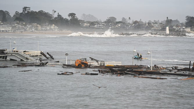 Officials conduct rescues after a portion of the Santa Cruz wharf was destroyed by powerful waves on Monday.