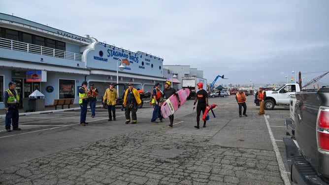 Officials conduct rescues after a portion of the Santa Cruz wharf was destroyed by powerful waves on Monday.