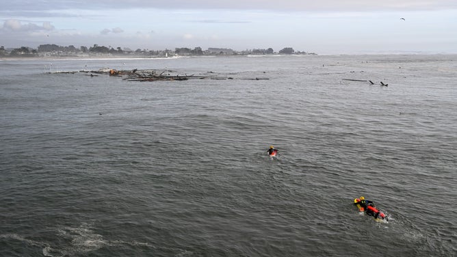 Officials conduct rescues after a portion of the Santa Cruz wharf was destroyed by powerful waves on Monday.