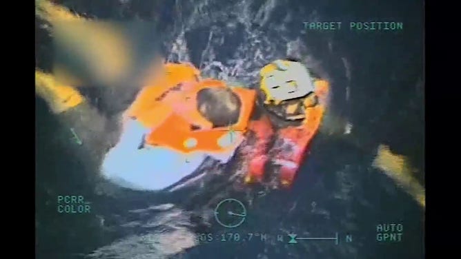 This photo shows one of two men being rescued from the water after their boat capsized off Puerto Rico over the weekend.