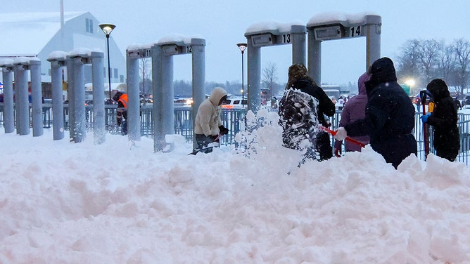 Crews work to clear snow from the field before a game between the Buffalo Bills and the San Francisco 49ers at Highmark Stadium on December 01, 2024 in Orchard Park, New York.