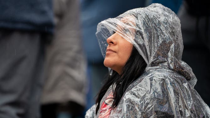 FILE: Revelers wait in the rain at Times Square for the midnight ball drop for the New Year's Eve celebration on December 31, 2022 in New York City.