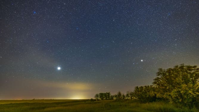 Jupiter (bright at left in Pisces) and Saturn (dimmer at right in Capricornus) low in the southeast sky on a mid-September evening in 2022 when Jupiter was nearing its opposition.