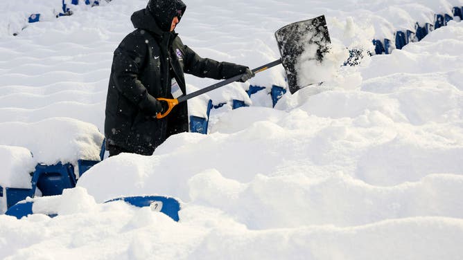 Crews work to clear snow from the field before a game between the Buffalo Bills and the San Francisco 49ers at Highmark Stadium on December 01, 2024 in Orchard Park, New York.