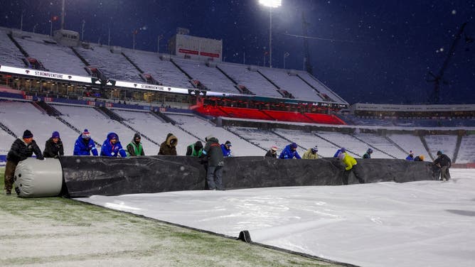 Crews work to clear snow from the field before a game between the Buffalo Bills and the San Francisco 49ers at Highmark Stadium on December 01, 2024 in Orchard Park, New York.
