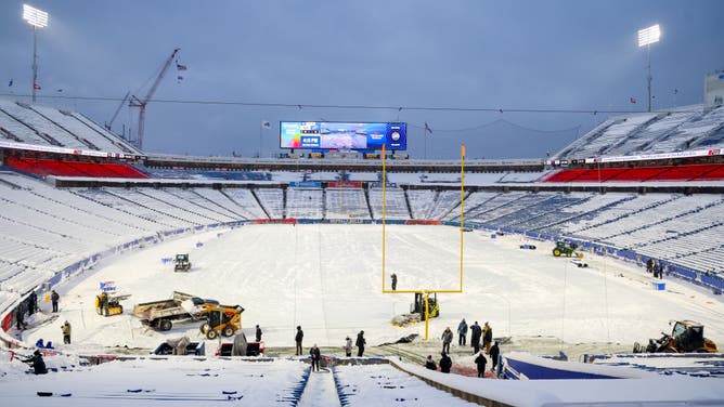 Crews work to clear snow from the field before a game between the Buffalo Bills and the San Francisco 49ers at Highmark Stadium on December 01, 2024 in Orchard Park, New York.