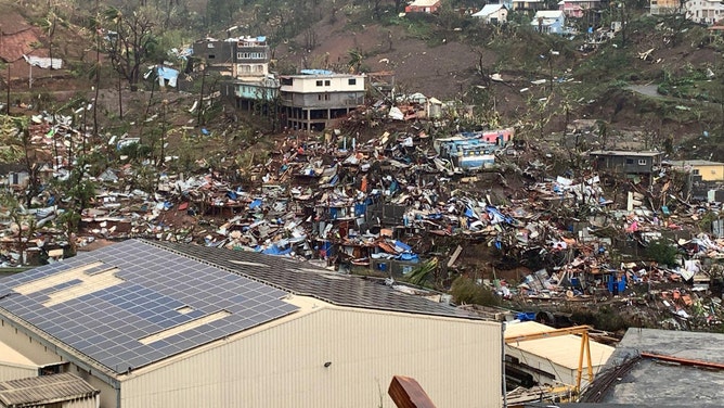 A photo taken on December 15, 2024 shows a pile of debris of metal sheets, wood, furniture and belongings after the cyclone Chido hit France's Indian Ocean territory of Mayotte.