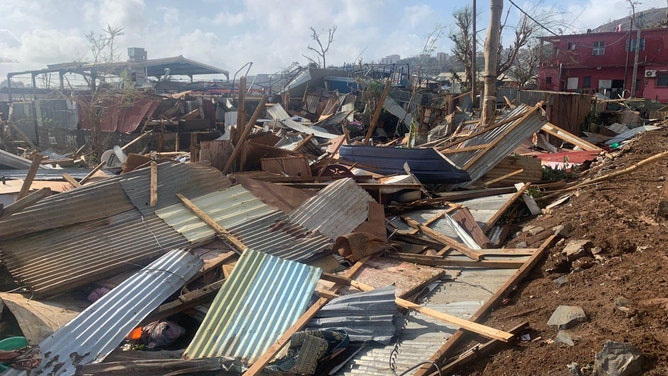 A photo taken on December 15, 2024 shows a pile of debris of metal sheets and wood after the cyclone Chido hit France's Indian Ocean territory of Mayotte.