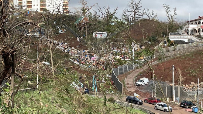 A photo taken on December 15, 2024 shows a pile of debris of metal sheets, wood, furniture and belongings after the cyclone Chido hit France's Indian Ocean territory of Mayotte.