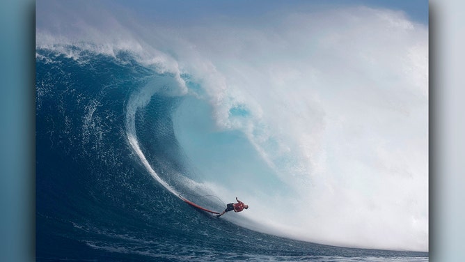 Tahitian surfer Eimeo Czermak wipes out on a wave at the Pe'ahi Jaws Surf Break on the island of Maui, Hawaii, on December 21, 2024.
