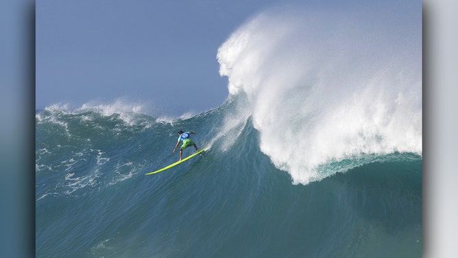 Hawaiian surfer Luke Shepardson catches a wave during the 2024 Rip Curl Eddie Aikau Big Wave invitational on the north shore of Oahu, Hawaii, on December 22, 2024.