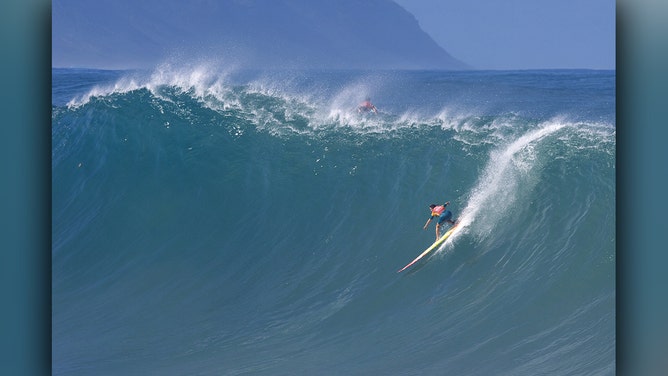 US surfer Bianca Valenti catches a wave during the 2024 Rip Curl Eddie Aikau Big Wave invitational on the north shore of Oahu, Hawaii, on December 22, 2024.